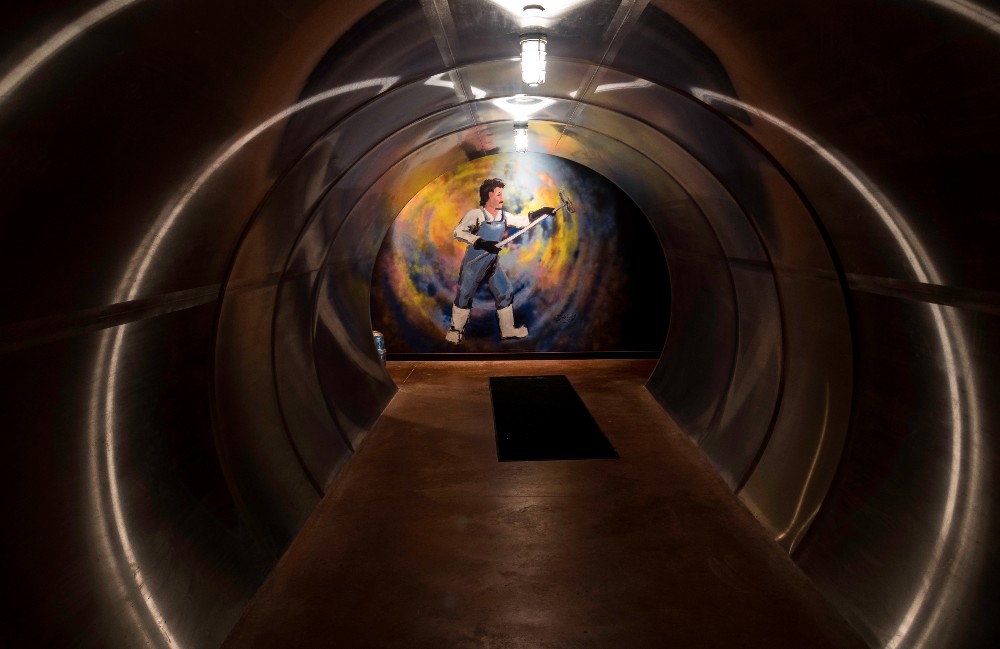 A mural decorates a wall at the end of a tunnel at New Glarus Brewery.
